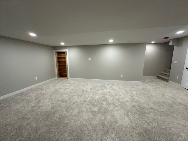 basement featuring light carpet