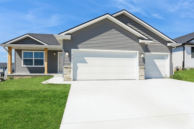 view of front of home with a garage and a front lawn