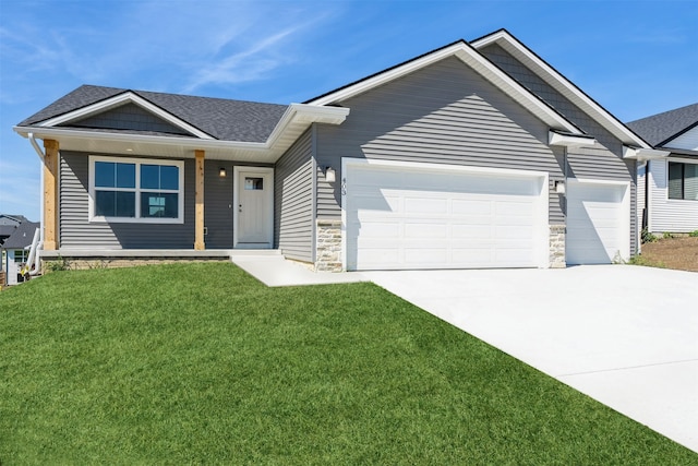 view of front of house with a front yard and a garage