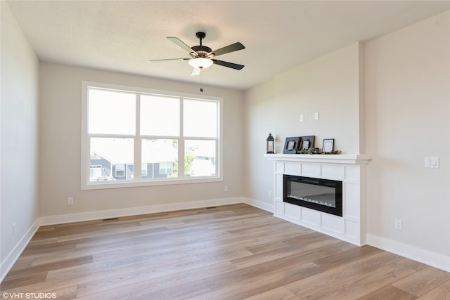 unfurnished living room featuring ceiling fan and light hardwood / wood-style flooring