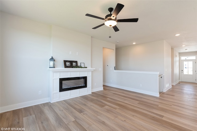 unfurnished living room featuring light hardwood / wood-style floors and ceiling fan