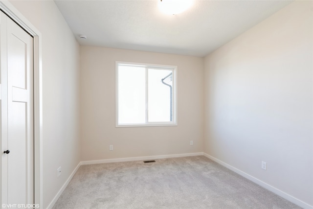 empty room featuring light carpet