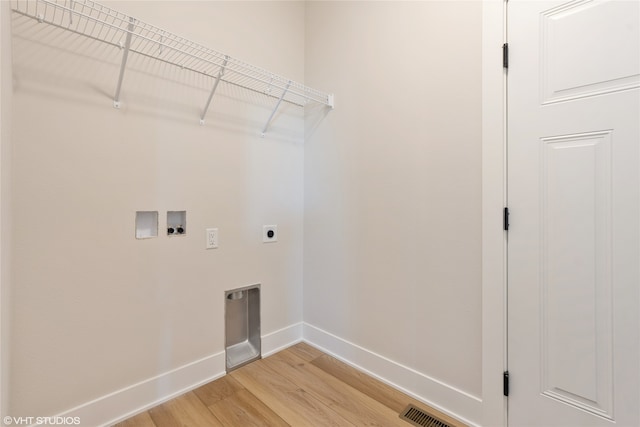 laundry area with washer hookup, hookup for an electric dryer, and light hardwood / wood-style flooring