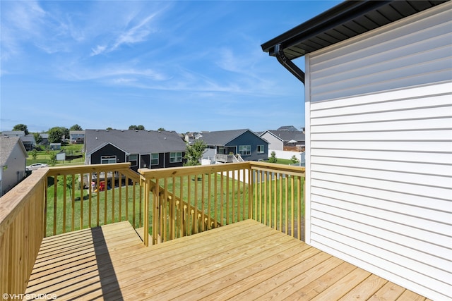 wooden terrace featuring a yard