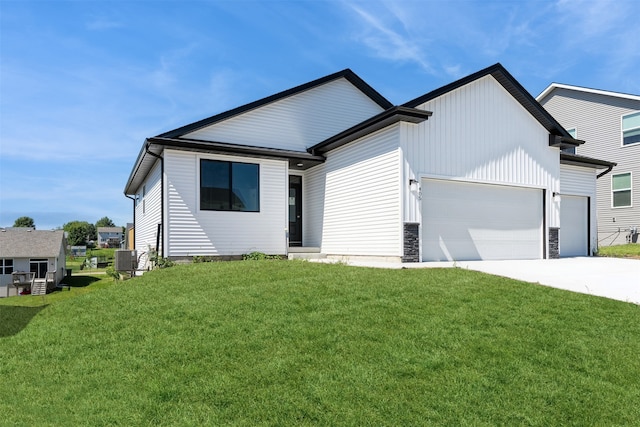 view of front of house featuring central AC, a front lawn, and a garage