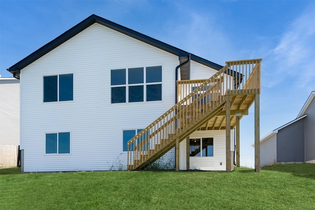 rear view of house featuring a deck and a yard