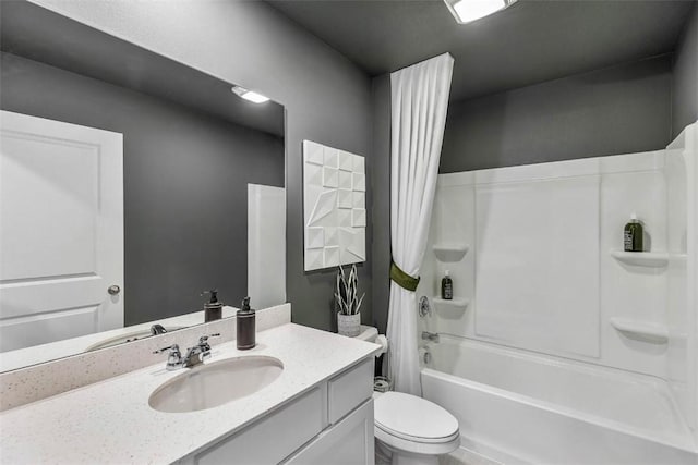 bathroom featuring toilet, shower / bath combo with shower curtain, and vanity