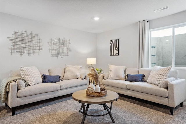 living area with carpet floors, recessed lighting, and visible vents