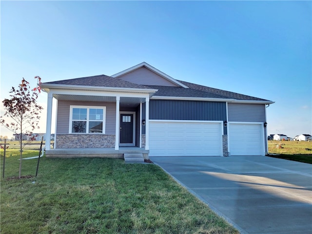 view of front of home with a garage and a front lawn