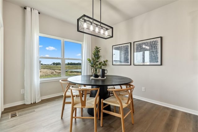 dining space with hardwood / wood-style flooring