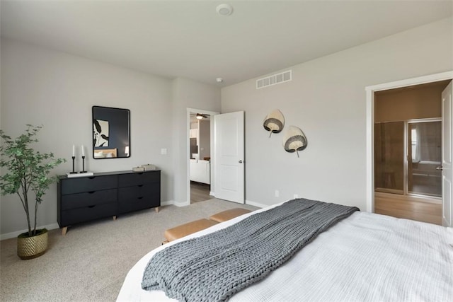 carpeted bedroom featuring ensuite bathroom