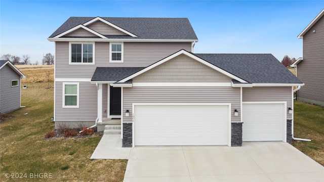 view of front facade with a front yard and a garage