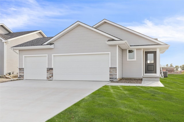 316 Fireside Dr NW, Bondurant, IA 50035 - view of front of property featuring concrete driveway, stone siding, a shingled roof, an attached garage, and a front lawn