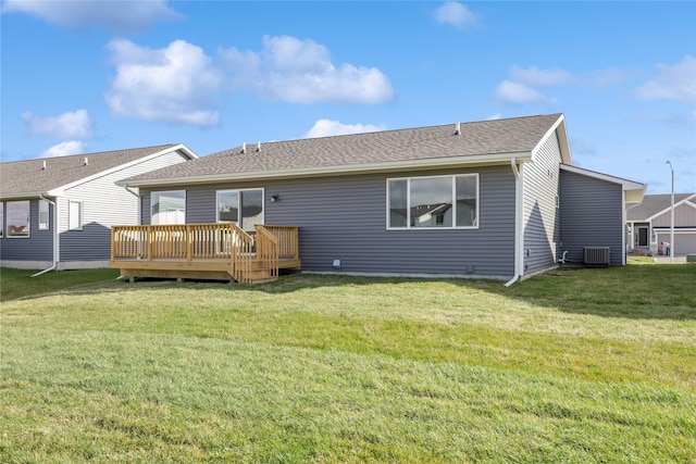 back of house featuring a lawn, a wooden deck, and cooling unit