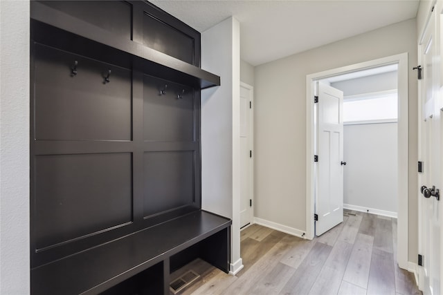 mudroom with light hardwood / wood-style floors