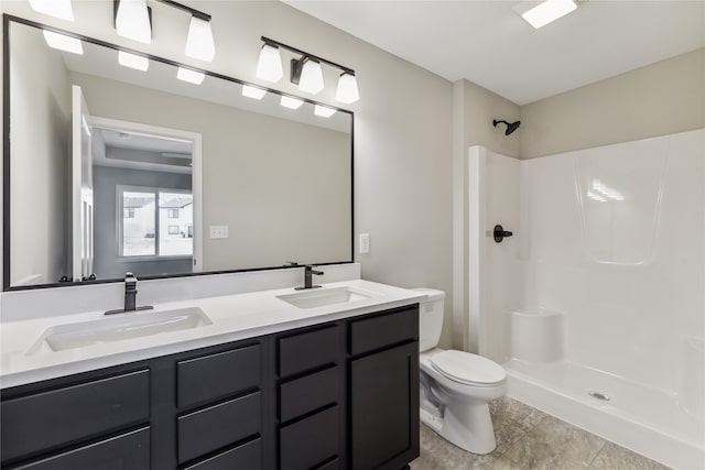 bathroom featuring tile patterned floors, vanity, toilet, and walk in shower