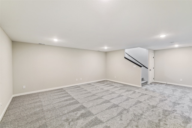 basement featuring light colored carpet