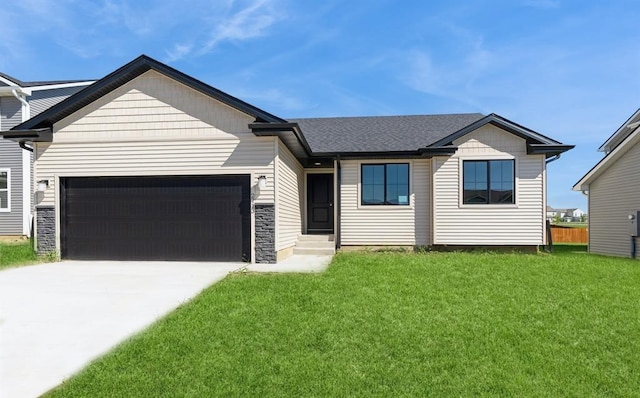 view of front facade with a front yard and a garage