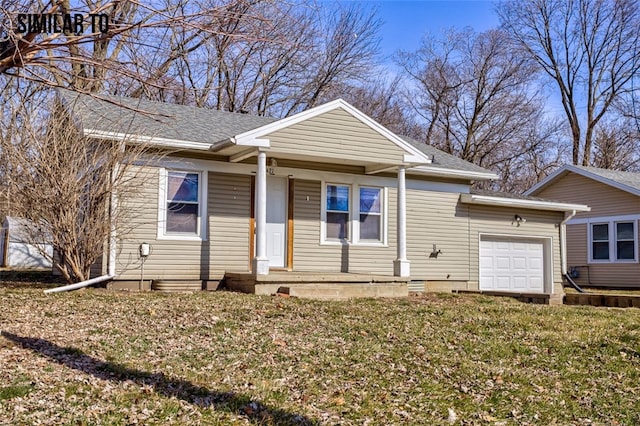 view of front of property with a garage and a front lawn