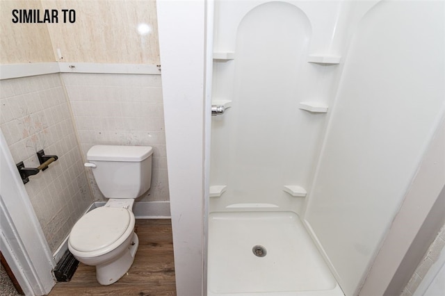 bathroom featuring tile walls, a shower, toilet, and hardwood / wood-style floors