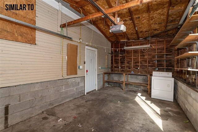 garage featuring a garage door opener and washer / clothes dryer