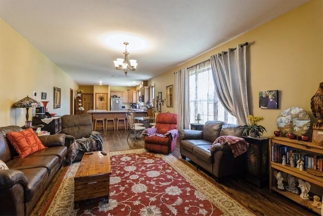 living room featuring an inviting chandelier and wood finished floors