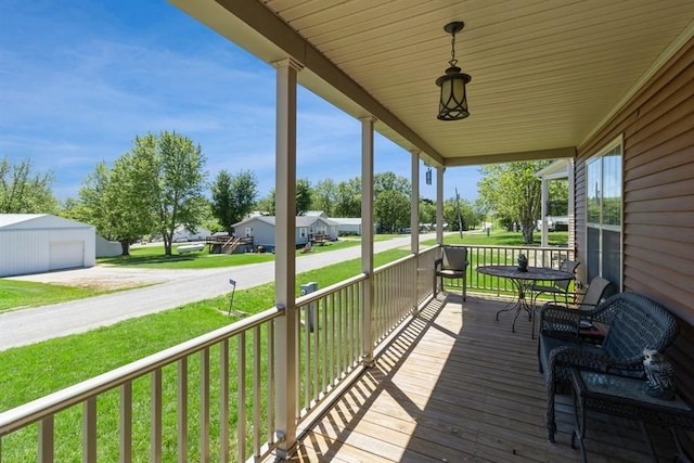 wooden terrace with a garage and covered porch