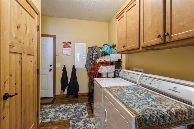 clothes washing area with a textured ceiling, cabinet space, dark wood-style flooring, and washing machine and clothes dryer