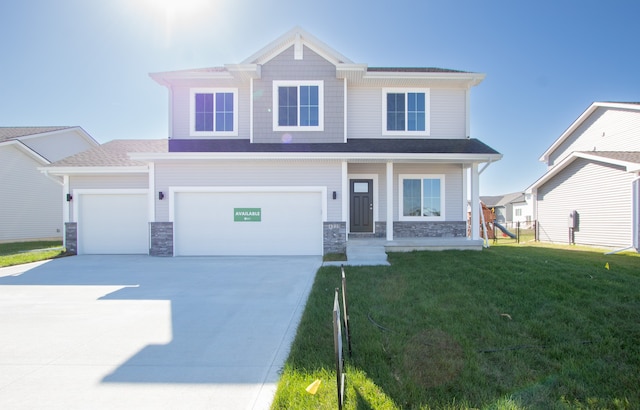 view of front of home with a garage and a front lawn