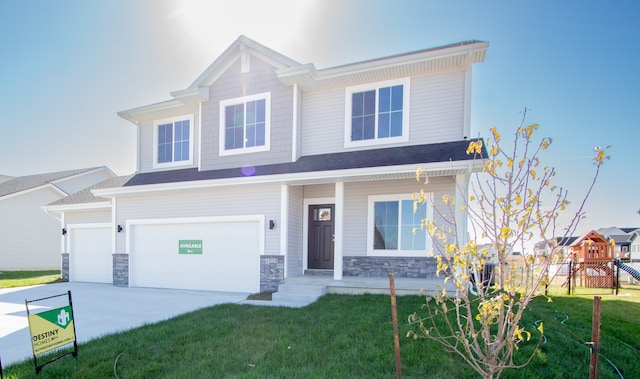 view of front of property featuring a front yard and a garage