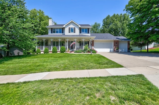 colonial inspired home with a garage, a front yard, and covered porch