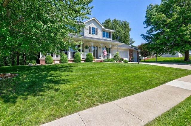 farmhouse inspired home featuring a garage, a front yard, and covered porch