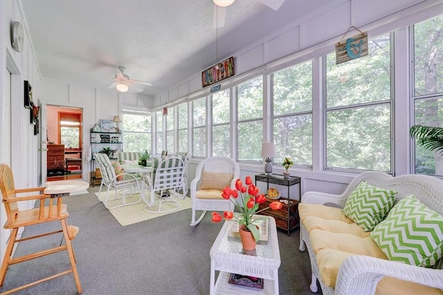 sunroom / solarium with a healthy amount of sunlight and ceiling fan