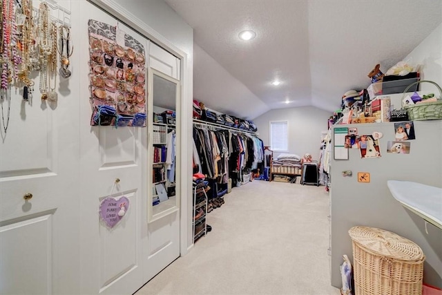 spacious closet featuring lofted ceiling and carpet flooring