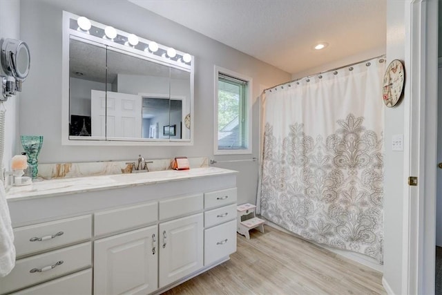 bathroom with vanity and wood-type flooring