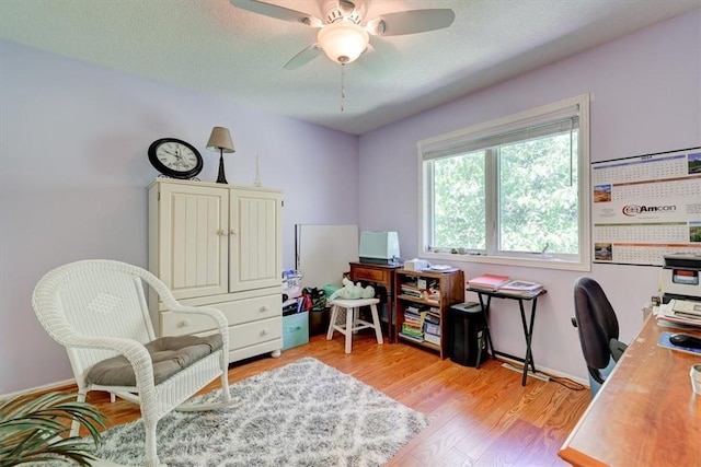 office area featuring ceiling fan, a textured ceiling, and light wood-type flooring