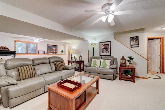 carpeted living room featuring a textured ceiling and ceiling fan