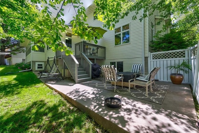 back of property with a patio, a lawn, and a fire pit