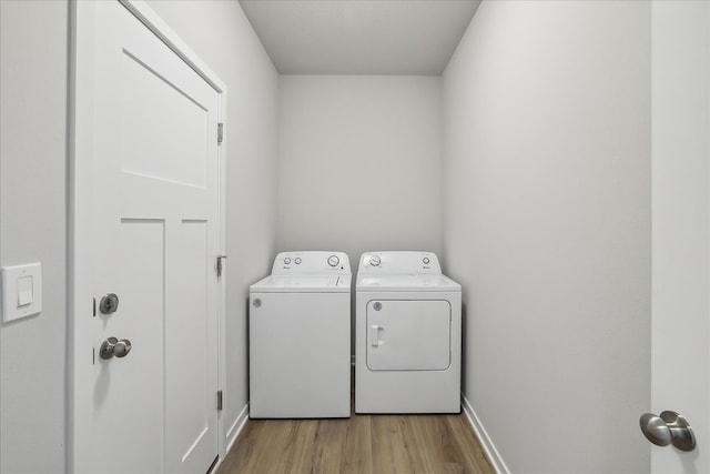 laundry room featuring light wood-style floors, laundry area, baseboards, and separate washer and dryer