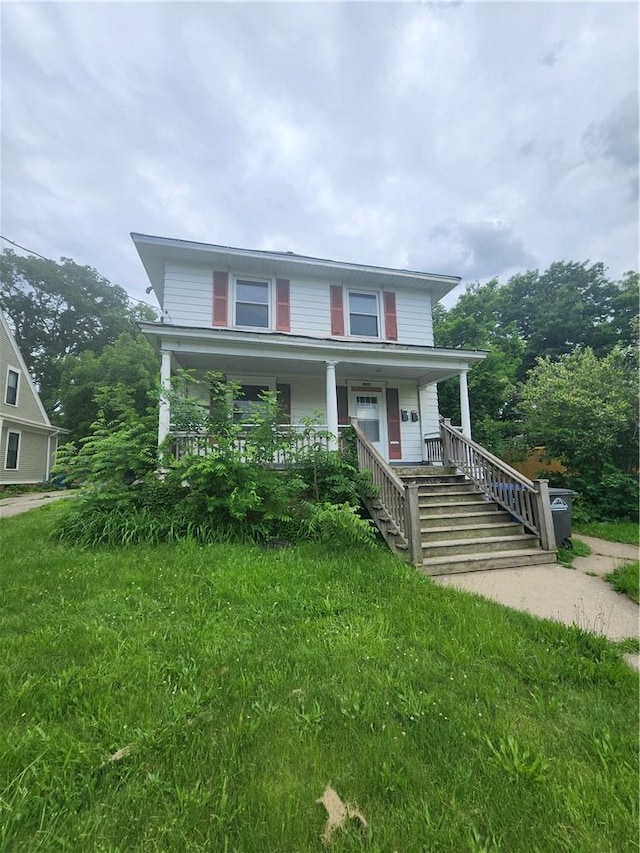 view of front of house with a front lawn and covered porch