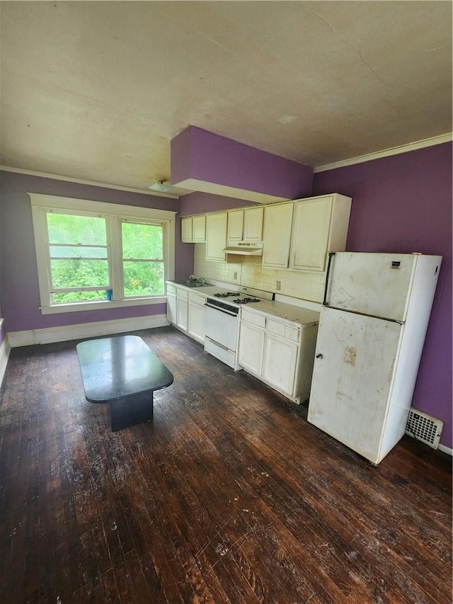 kitchen featuring white cabinetry, tasteful backsplash, dark hardwood / wood-style floors, white appliances, and ornamental molding