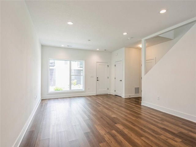 spare room featuring dark wood-type flooring