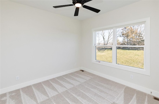 carpeted spare room featuring a healthy amount of sunlight