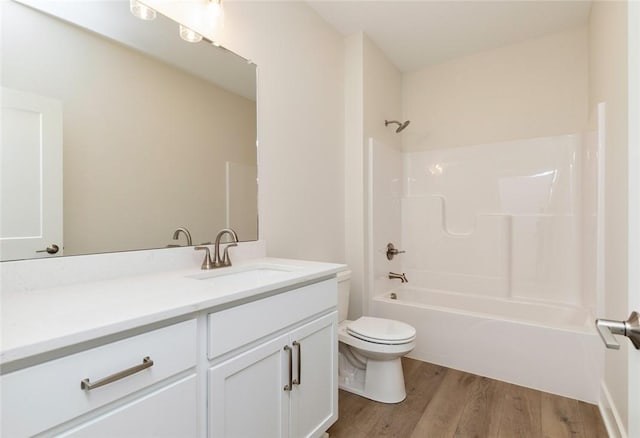 full bathroom with vanity, tub / shower combination, toilet, and hardwood / wood-style floors