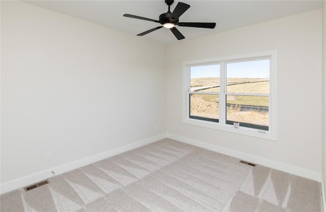 carpeted empty room featuring ceiling fan