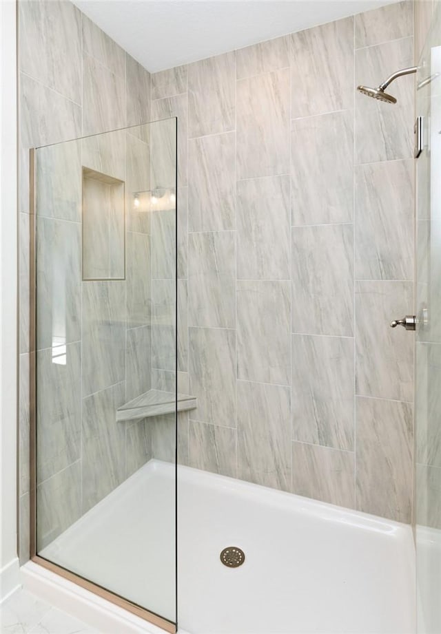 bathroom with tiled shower