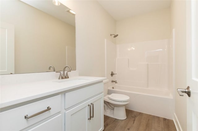 full bathroom with toilet, vanity, shower / bath combination, and wood-type flooring