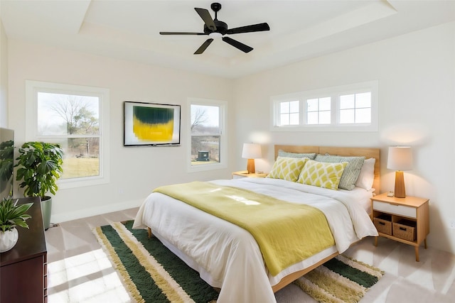 bedroom featuring a tray ceiling and ceiling fan