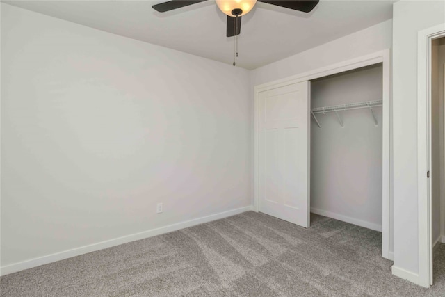 unfurnished bedroom with light colored carpet, ceiling fan, and a closet