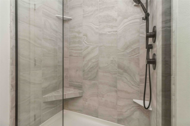 bathroom with a tile shower